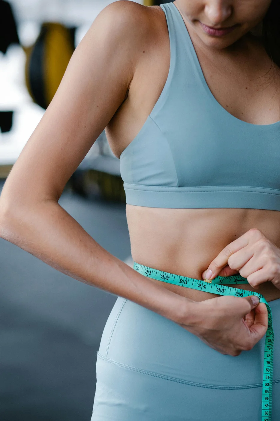 Woman measuring her waist supporting everyday weight-management goals with BurnTide